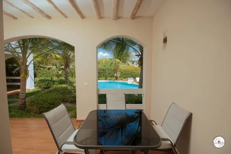 A dining table under arched windows