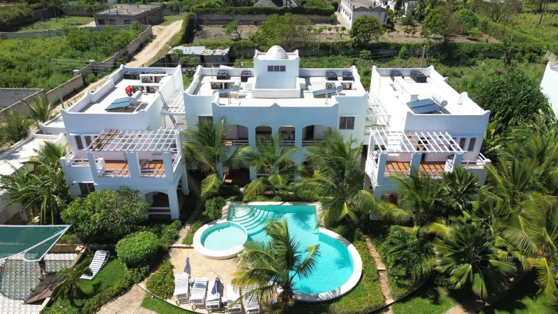 Agama Apartments and its pools seen from the air, among palm trees