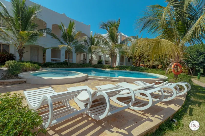 Sun loungers lined up beside the pool